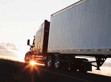 silhouette-of-a-commercial-truck-driving-on-a-highway-at-sunset-.jpg